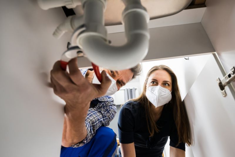 Plumber Repairing a Pipe